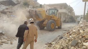 Courtesy of ASAID Emergency responders clear rubble in Maaret Nouman, Idleb, in November 2014.